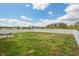 Expansive backyard with white fencing offering privacy, with a concrete patio and outdoor seating area at 1110 Bent Willow Dr, Durham, NC 27704