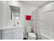 Bright bathroom with a modern white vanity, large mirror, and shower-tub combo with patterned curtain at 1110 Bent Willow Dr, Durham, NC 27704