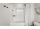 White shower-tub combination features a shower curtain and shelving inside the tub at 1110 Bent Willow Dr, Durham, NC 27704
