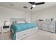 Cozy bedroom features a bed with storage, a dresser, and a ceiling fan at 1110 Bent Willow Dr, Durham, NC 27704