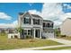 Charming two-story home features a manicured lawn, gray siding, black shutters, and a two-car garage at 1110 Bent Willow Dr, Durham, NC 27704