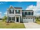 Charming two-story home featuring a gray exterior, a two-car garage, and a well-maintained lawn at 1110 Bent Willow Dr, Durham, NC 27704