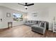 Inviting living room featuring hardwood floors, a comfortable gray sofa, and large windows for natural light at 1110 Bent Willow Dr, Durham, NC 27704