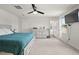 Bright bedroom features a ceiling fan, plush carpet, dresser, and access to the ensuite bathroom at 1110 Bent Willow Dr, Durham, NC 27704