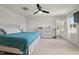 Spacious bedroom with a ceiling fan, ensuite bathroom, and bright natural light from windows at 1110 Bent Willow Dr, Durham, NC 27704