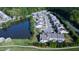 Aerial view of a neighborhood featuring a serene pond, tree-lined streets, and well-maintained homes at 112 Red Admiral Ct, Hillsborough, NC 27278
