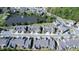 Aerial view showcasing townhomes near a small pond and fountain, set within a community neighborhood at 112 Red Admiral Ct, Hillsborough, NC 27278