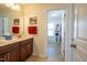 Well-lit bathroom featuring a double vanity, granite countertops, and a view into the tiled shower area at 112 Red Admiral Ct, Hillsborough, NC 27278