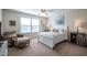 Comfortable bedroom features natural light, a queen bed, and tasteful décor perfect for relaxation and rest at 112 Red Admiral Ct, Hillsborough, NC 27278