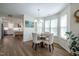 Eat-in dining area with hardwood floors, natural light, and views of the kitchen at 112 Red Admiral Ct, Hillsborough, NC 27278