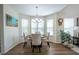 Sunlit dining area with hardwood floors and modern chandelier at 112 Red Admiral Ct, Hillsborough, NC 27278