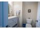 Cozy half bathroom features a white vanity, round mirror, and decorative wall art for a warm atmosphere at 112 Red Admiral Ct, Hillsborough, NC 27278