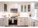 Modern kitchen with stainless steel appliances, white cabinets, and granite countertops at 112 Red Admiral Ct, Hillsborough, NC 27278