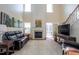 Open-concept living room with a fireplace and large windows for plenty of natural light at 112 Red Admiral Ct, Hillsborough, NC 27278