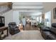 Comfortable living room with wood floors, a view of the dining area and kitchen, and staircase to the upper level at 112 Red Admiral Ct, Hillsborough, NC 27278