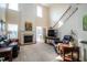 Spacious living room with a fireplace, high ceilings, and access to a screened-in porch at 112 Red Admiral Ct, Hillsborough, NC 27278