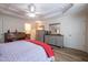 Spacious main bedroom featuring wood-look floors, a decorative tray ceiling and access to main bathroom at 112 Red Admiral Ct, Hillsborough, NC 27278