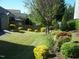 Beautifully landscaped backyard featuring vibrant flower beds, a well-maintained lawn, and privacy fence at 1215 Agile Dr, Knightdale, NC 27545