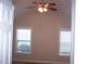 Room with vaulted ceiling, ceiling fan, carpet flooring, and two windows allowing natural light at 1215 Agile Dr, Knightdale, NC 27545