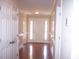 Bright entryway featuring hardwood floors, white trim, and a front door with sidelights at 1215 Agile Dr, Knightdale, NC 27545