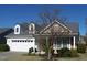 Charming home with a two-car garage and a well-maintained front yard with trees and shrubs at 1215 Agile Dr, Knightdale, NC 27545