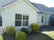 Charming home exterior with well-manicured landscaping, bright windows, and neutral siding at 1215 Agile Dr, Knightdale, NC 27545