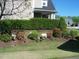 Well-kept front yard with manicured hedges and colorful flower beds at 1215 Agile Dr, Knightdale, NC 27545