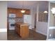 Spacious kitchen featuring wood cabinets, an island, tile backsplash, and modern appliances at 1215 Agile Dr, Knightdale, NC 27545