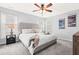 Spacious bedroom featuring a ceiling fan, carpet, and large windows for natural light at 12325 Inglehurst Dr, Raleigh, NC 27613