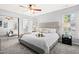 Bright bedroom showcasing a sliding door closet, carpet, and a view to an en suite bathroom at 12325 Inglehurst Dr, Raleigh, NC 27613