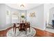 Bright dining area with hardwood floors, round table, and decorative accents near the living room at 12325 Inglehurst Dr, Raleigh, NC 27613