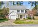 Charming two-story home with a well-manicured lawn, attached garage, and inviting front porch at 12325 Inglehurst Dr, Raleigh, NC 27613
