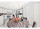 Eat-in kitchen area with white cabinets, stainless appliances, a round table and lots of storage at 12325 Inglehurst Dr, Raleigh, NC 27613