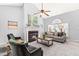 Inviting living room featuring a fireplace, large windows, and stylish furnishings for relaxing and entertaining at 12325 Inglehurst Dr, Raleigh, NC 27613