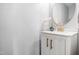 Stylish powder room with a modern vanity, round mirror, and elegant gold faucet at 12325 Inglehurst Dr, Raleigh, NC 27613