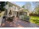 Expansive backyard with a deck, screened porch and a grill, surrounded by mature trees at 125 Kelekent Ln, Cary, NC 27518