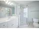 Bathroom with white vanity and sink, walk-in shower, and toilet in a well lit space at 125 Kelekent Ln, Cary, NC 27518