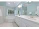 Bright bathroom featuring double vanity with modern fixtures, soaking tub, and a large mirror at 125 Kelekent Ln, Cary, NC 27518