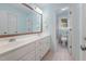 Bathroom displaying double sink vanity, large mirror, and a toilet in an adjacent room at 125 Kelekent Ln, Cary, NC 27518