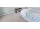 Bedroom featuring carpet, a blue patterned bedspread and a wooden side table with drawers at 125 Kelekent Ln, Cary, NC 27518