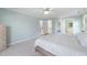 Bedroom with neutral colored walls, carpet, and bed, with en suite bathroom and closet at 125 Kelekent Ln, Cary, NC 27518