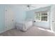Light blue bedroom featuring a white bedspread, ceiling fan, and natural light from the window at 125 Kelekent Ln, Cary, NC 27518