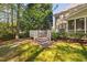 Spacious wooden deck with stairs and a seating area, perfect for outdoor entertaining in a serene backyard at 125 Kelekent Ln, Cary, NC 27518