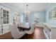 Bright dining room featuring a large table with seating for eight, a chandelier, and built-in cabinetry at 125 Kelekent Ln, Cary, NC 27518