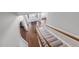 View from the top of the stairs to the foyer with hardwood floors and white door at 125 Kelekent Ln, Cary, NC 27518