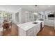 Bright kitchen with large island, stainless dishwasher, and views of the dining area at 125 Kelekent Ln, Cary, NC 27518