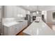 Bright white kitchen with a large island, modern appliances and a view of the staircase at 125 Kelekent Ln, Cary, NC 27518