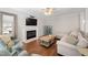 Comfortable living room showcasing a fireplace, built-in cabinets, hardwood floors, and neutral-toned furniture at 125 Kelekent Ln, Cary, NC 27518