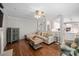 Open-concept living room with a partial view of the kitchen, hardwood floors, and comfortable seating at 125 Kelekent Ln, Cary, NC 27518