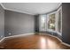 Office featuring gray walls, white trim, hardwood floors, and a bay window offering natural light at 125 Kelekent Ln, Cary, NC 27518